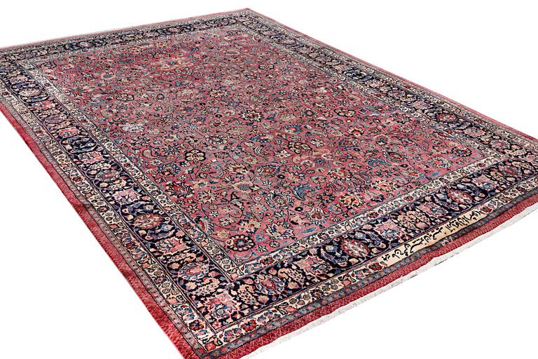 An antique Mashad carpet, signed Saber, c. 405 x 295 cm.
