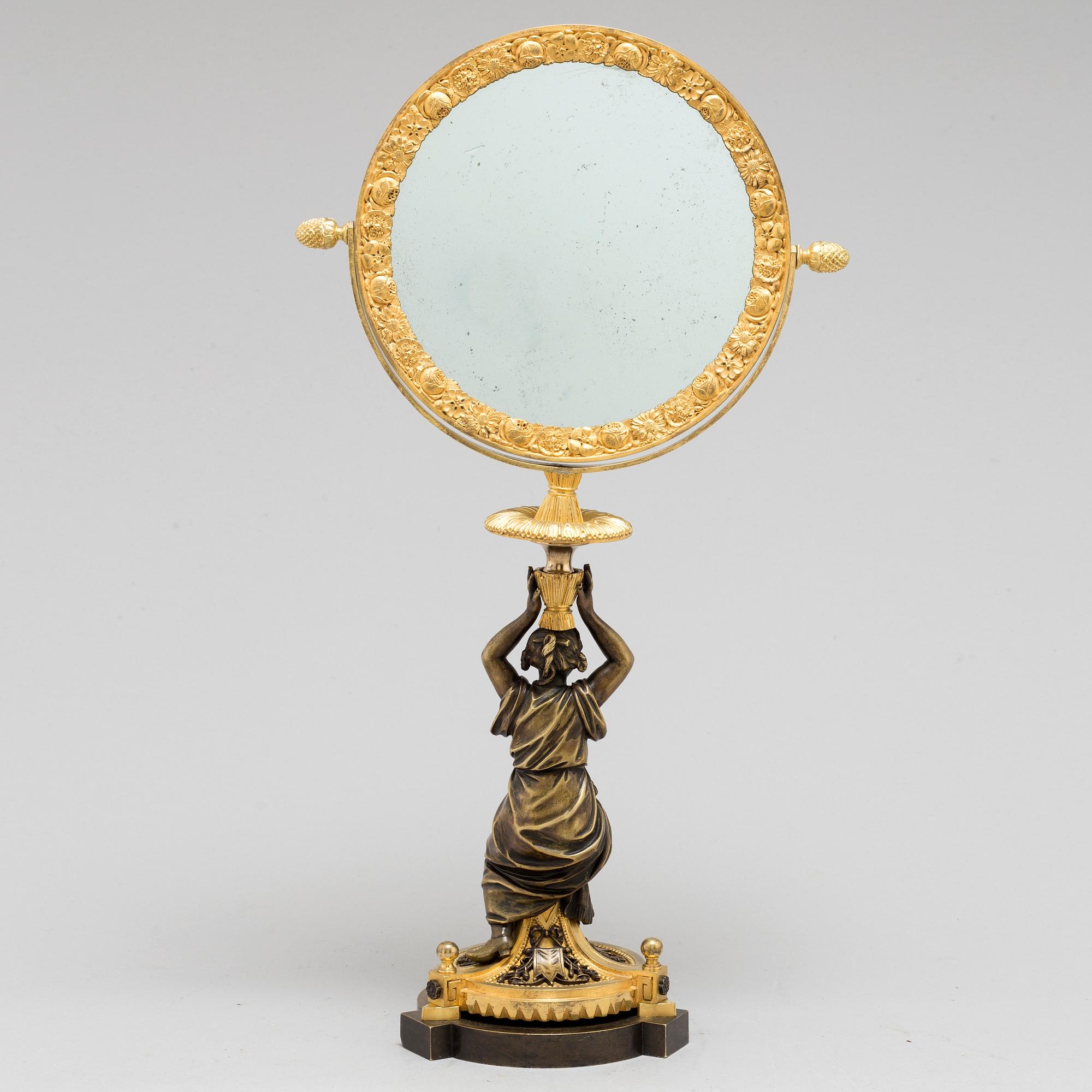 AN EMPIRE ORMOLU TABLE MIRROR, first half of the 19th century.