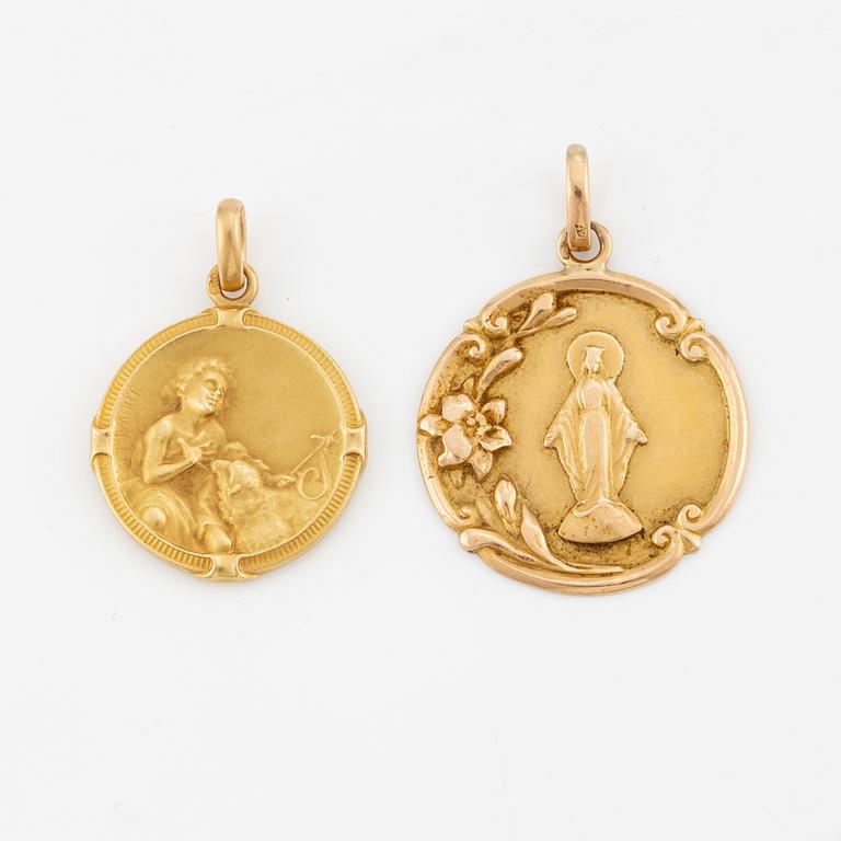 Two 18K gold medallions.