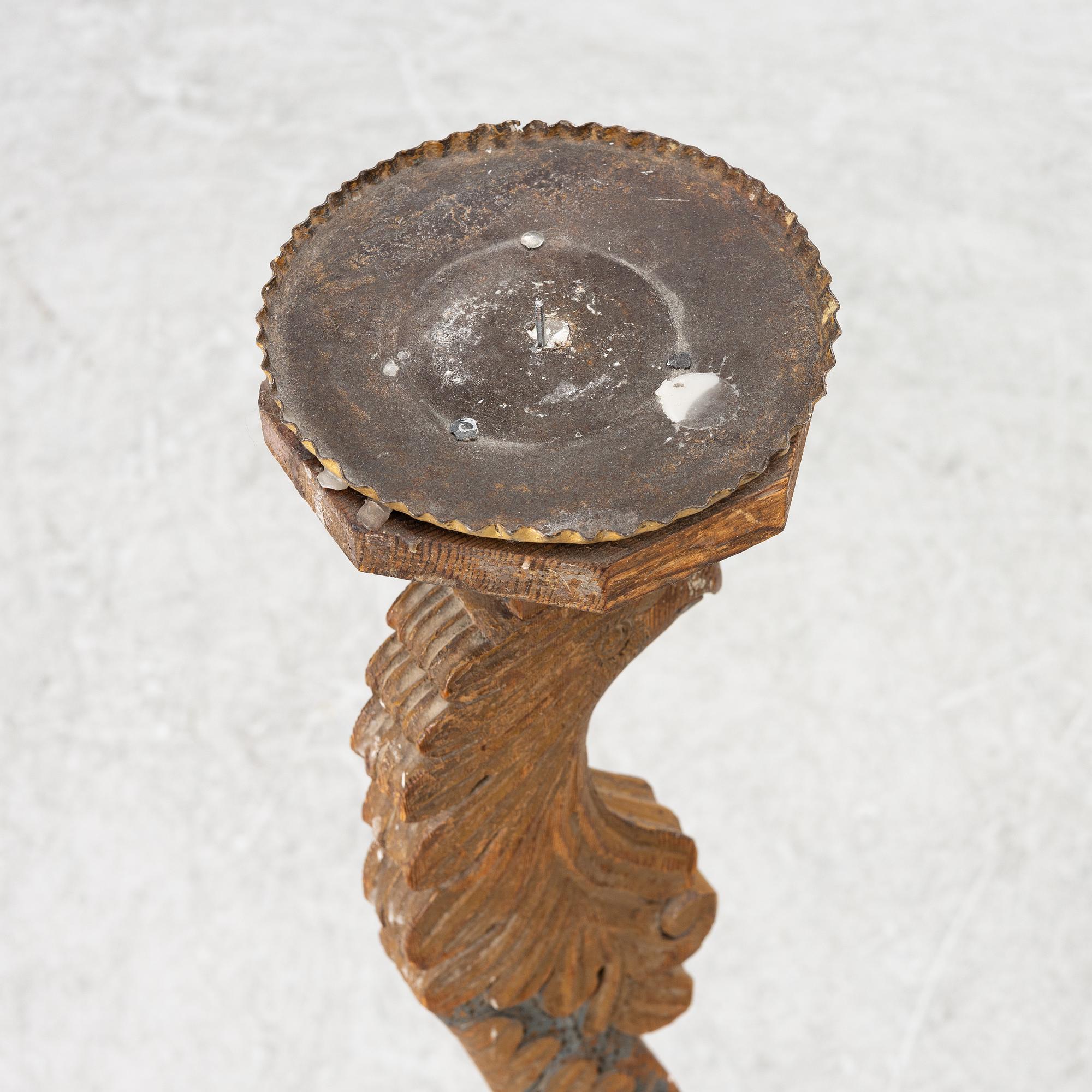 A carved wood floor candlestick, circa 1900 composed of 18th century elements.