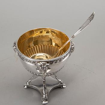 A silver bowl on foot, a pair of candlesticks and a spoon. early 20th century. Total weight app. 800 gram.