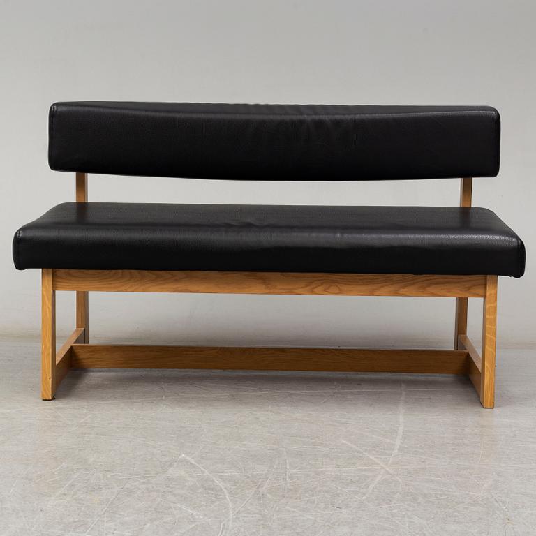 A leather covered oak sofa, 21st Century.