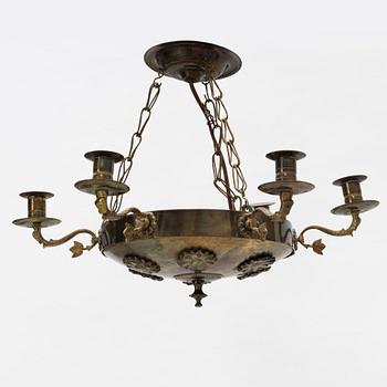 An empire style brass chandelier, around 1900.