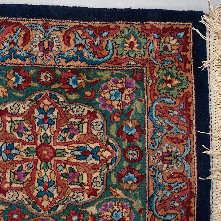 A CARPET. A semi-antique Kerman. 614,5 x 360,5 cm.