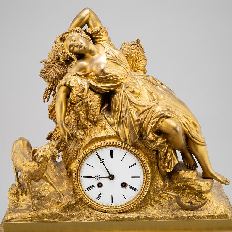 A mid 19th Century brass and gilt brass mantel clock.