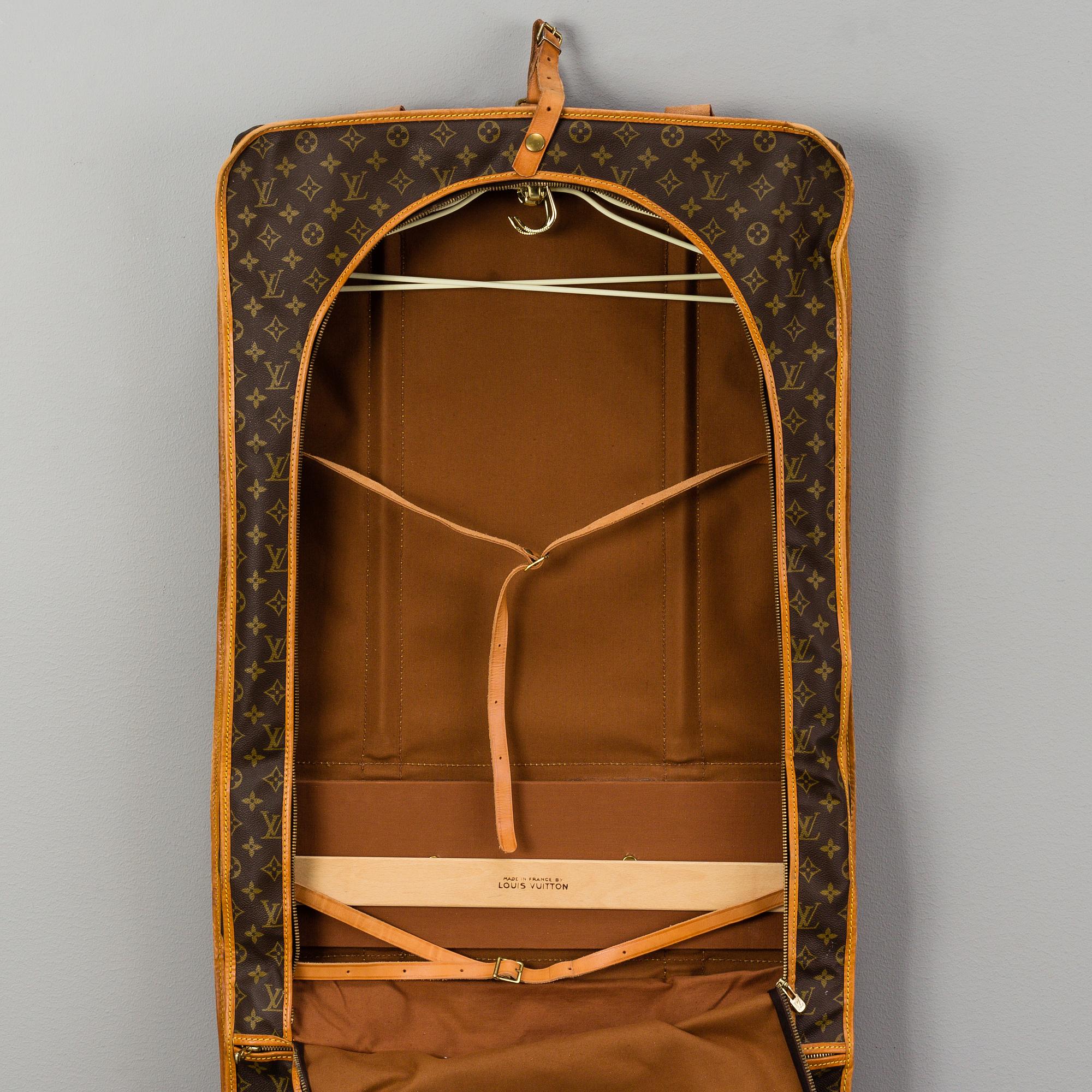 A Louis Vuitton vintage Monogram Canvas Homme Garment Bag.