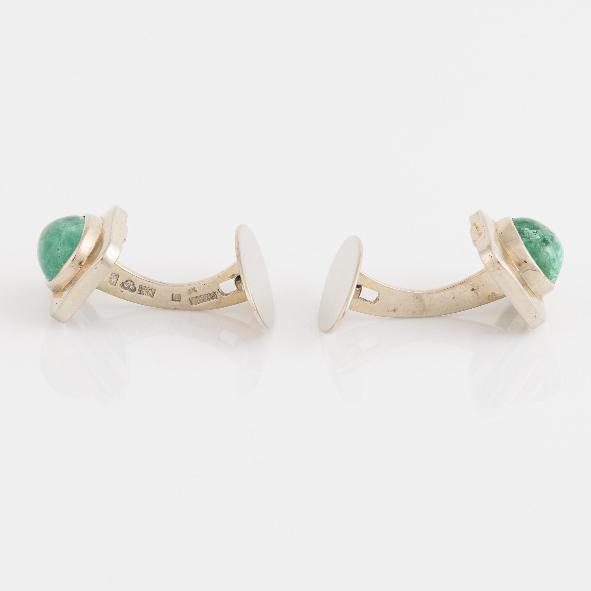 18K white gold and cabochon cut emerald cufflinks.
