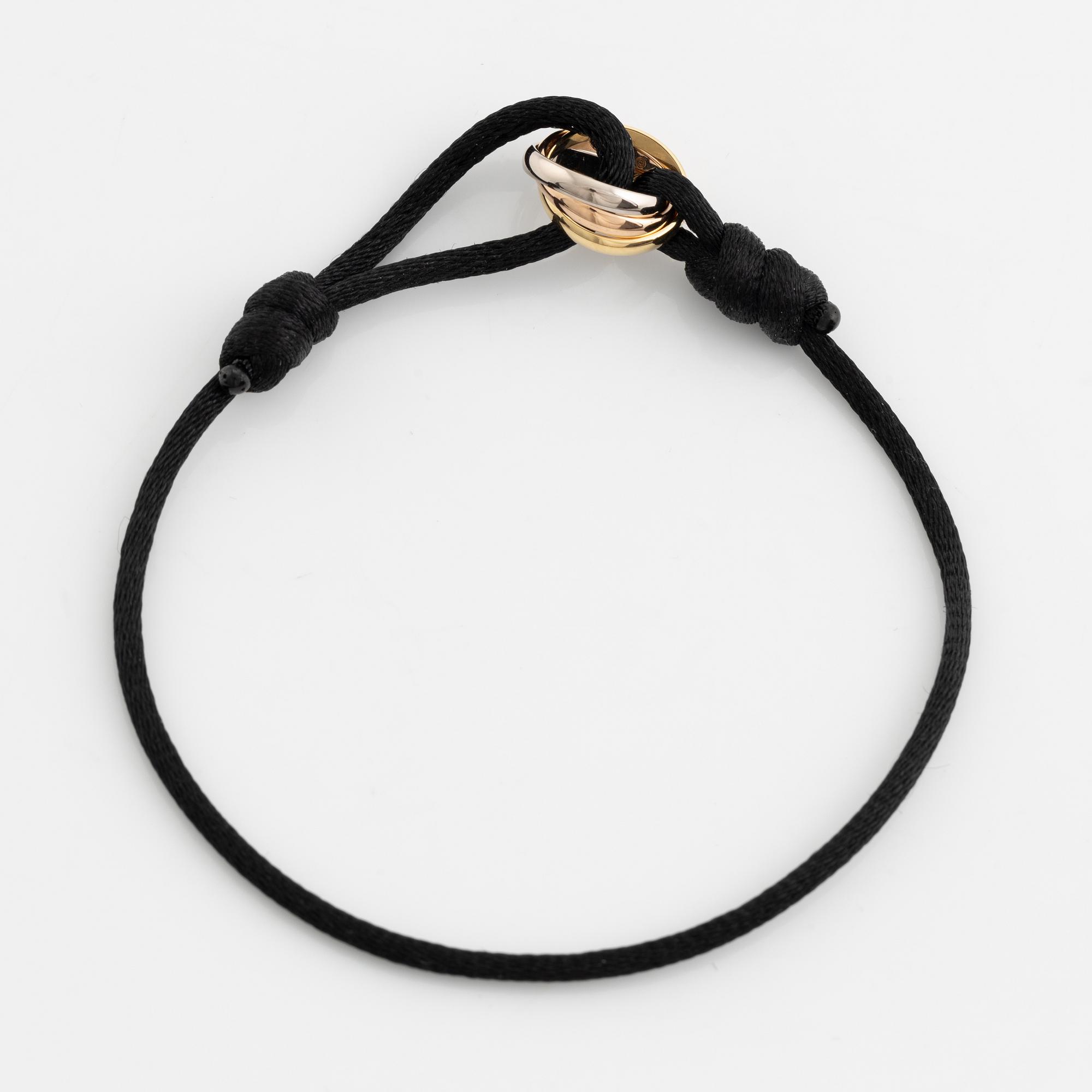 A Cartier "Trinity" bracelet, 18K three colour gold and textile.