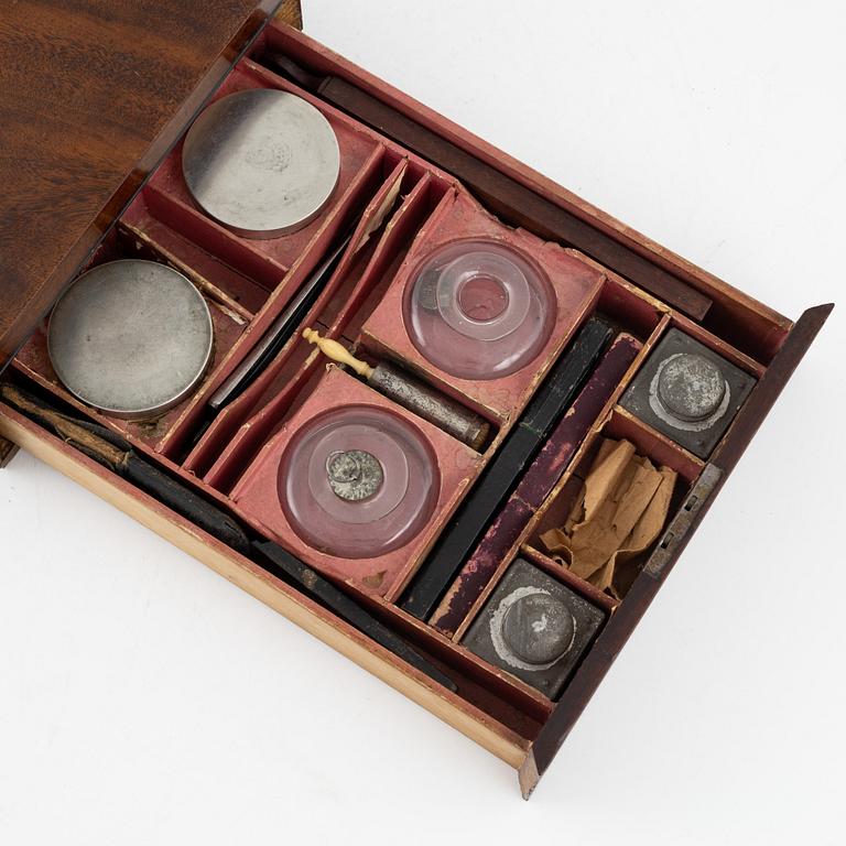 An early 19th century mahogny-veneered box for shaving utensils.