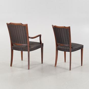 An english style dining table and eight chairs, second half of the 20th century.