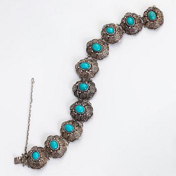 A bracelet and pair of earrings in silver with turquoises. Import marked Risto Aho, Helsinki 1964.