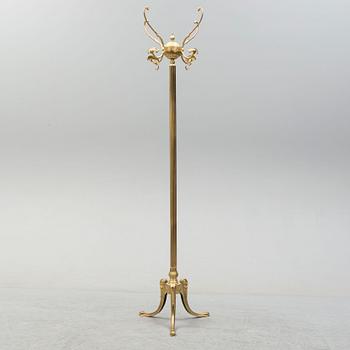 a brass coat hanger from the late 20th century.