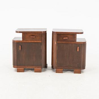 A pair of stained wood bedside tables from the first half of the 20th century.