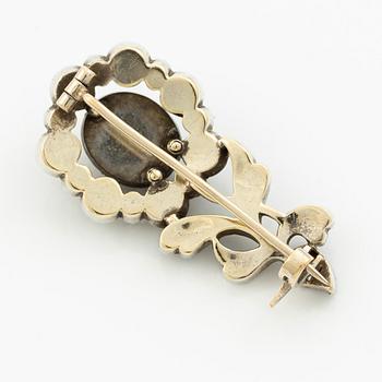 Brooch in silver set with rose-cut diamonds in the shape of a flower.