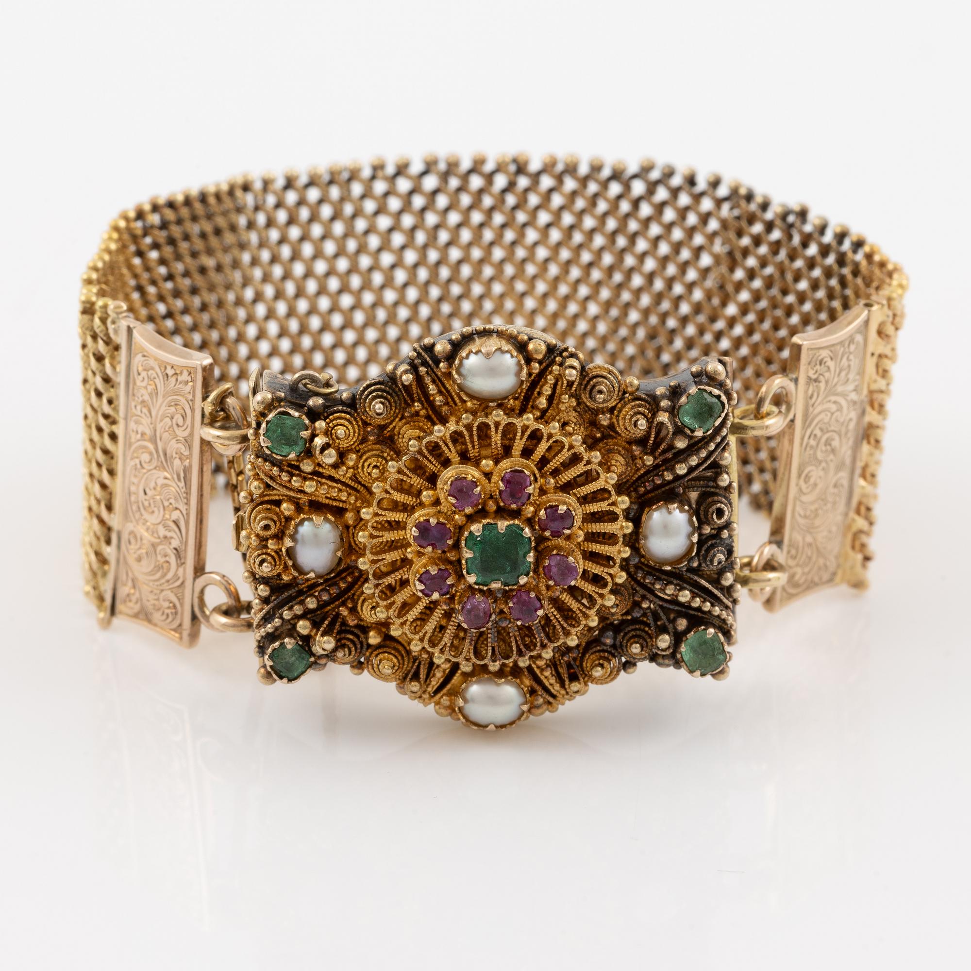 Bracelet in gold with pearls, emeralds, and rubies.