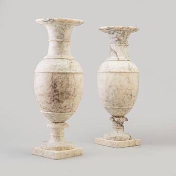 A pair of marble urns, circa 1900.