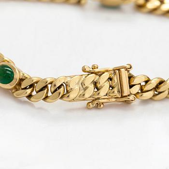 An 18K gold curb link bracelet with cabochon-cut green garnets.