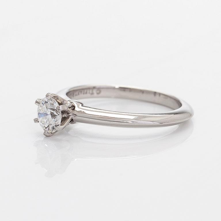 Tiffany & Co, a platinum solitaire ring with a brilliant-cut diamond.