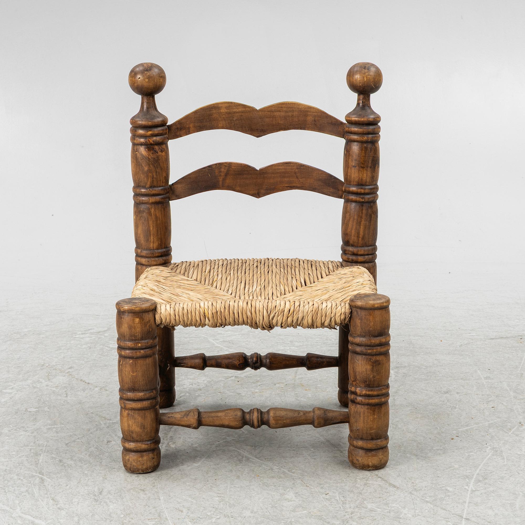 Charles Dudouyt, attributed to, a fireside low chair, mid 20th century.