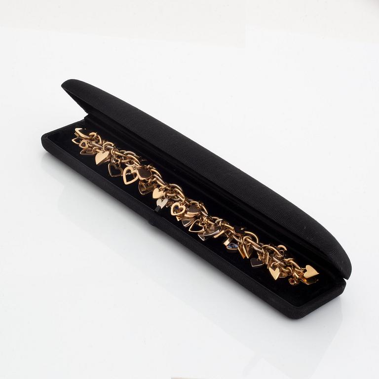 An 18K gold Gaudy bracelet with heart shaped charms.