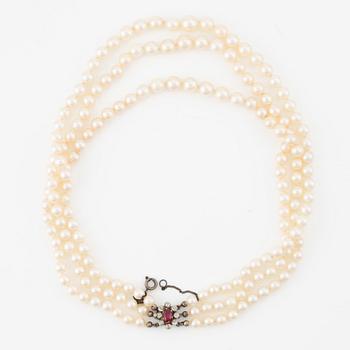 Pearl necklace, three strands, with graduated cultured pearls, gold set with old-cut diamonds and synthetic ruby.