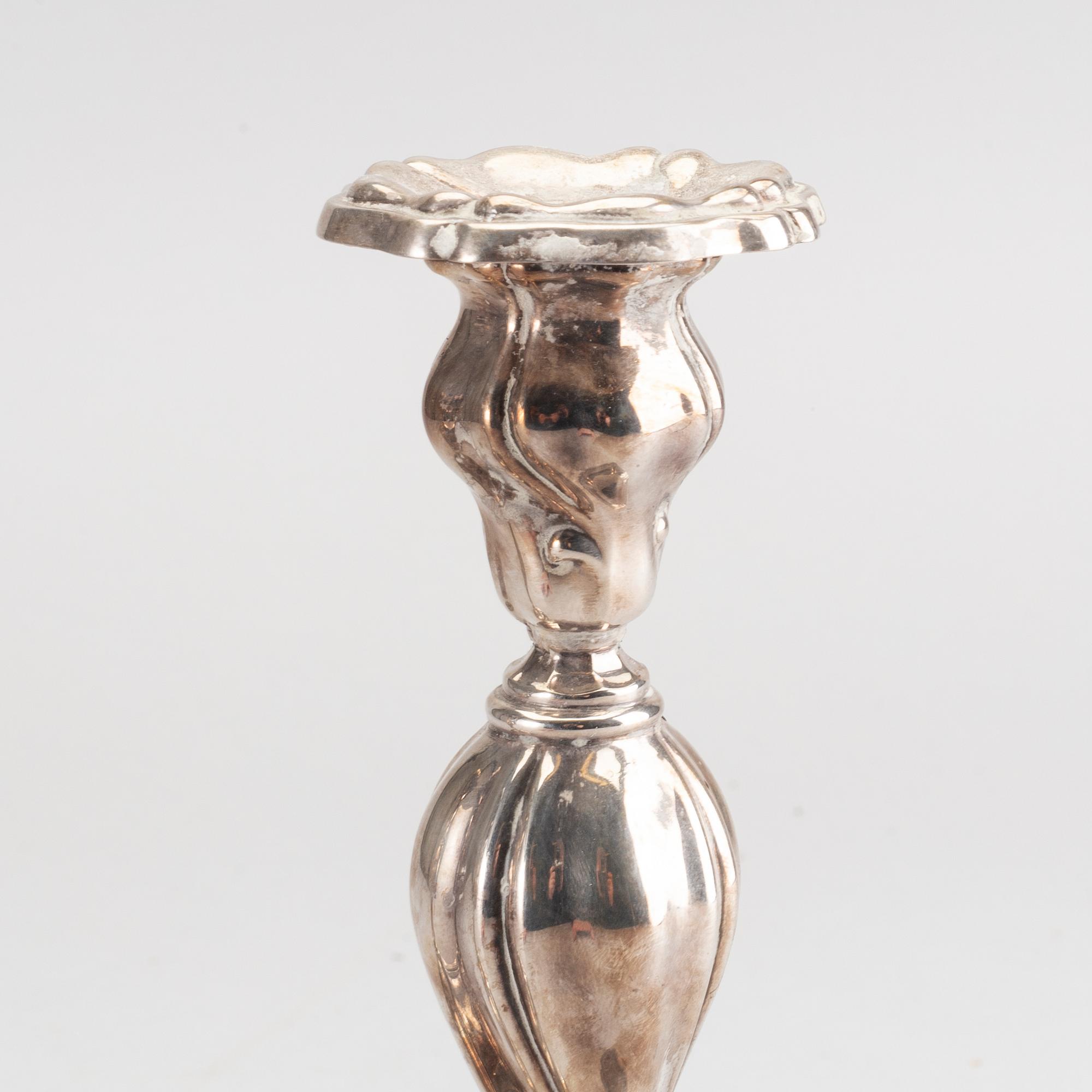 A 20th century pair of silver candle sticks rococo-style, height ca 22 cm.