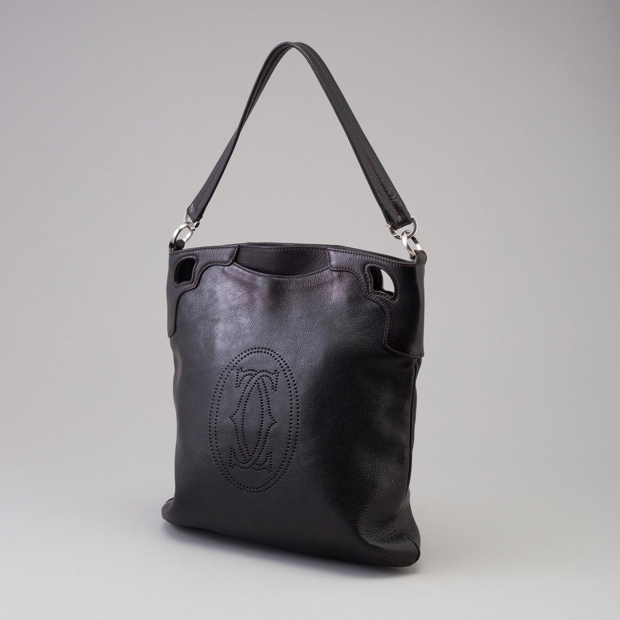 A bag "Marcello Reporter" by Cartier.