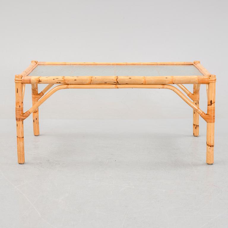 A set of two garden sofas, an armchair and a glass table, later part of the 20th Century.