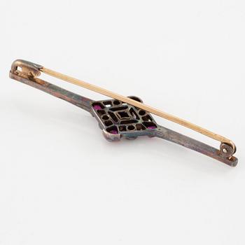 Brooch platinum and 14K gold set with old- and rose-cut diamonds and red stones.