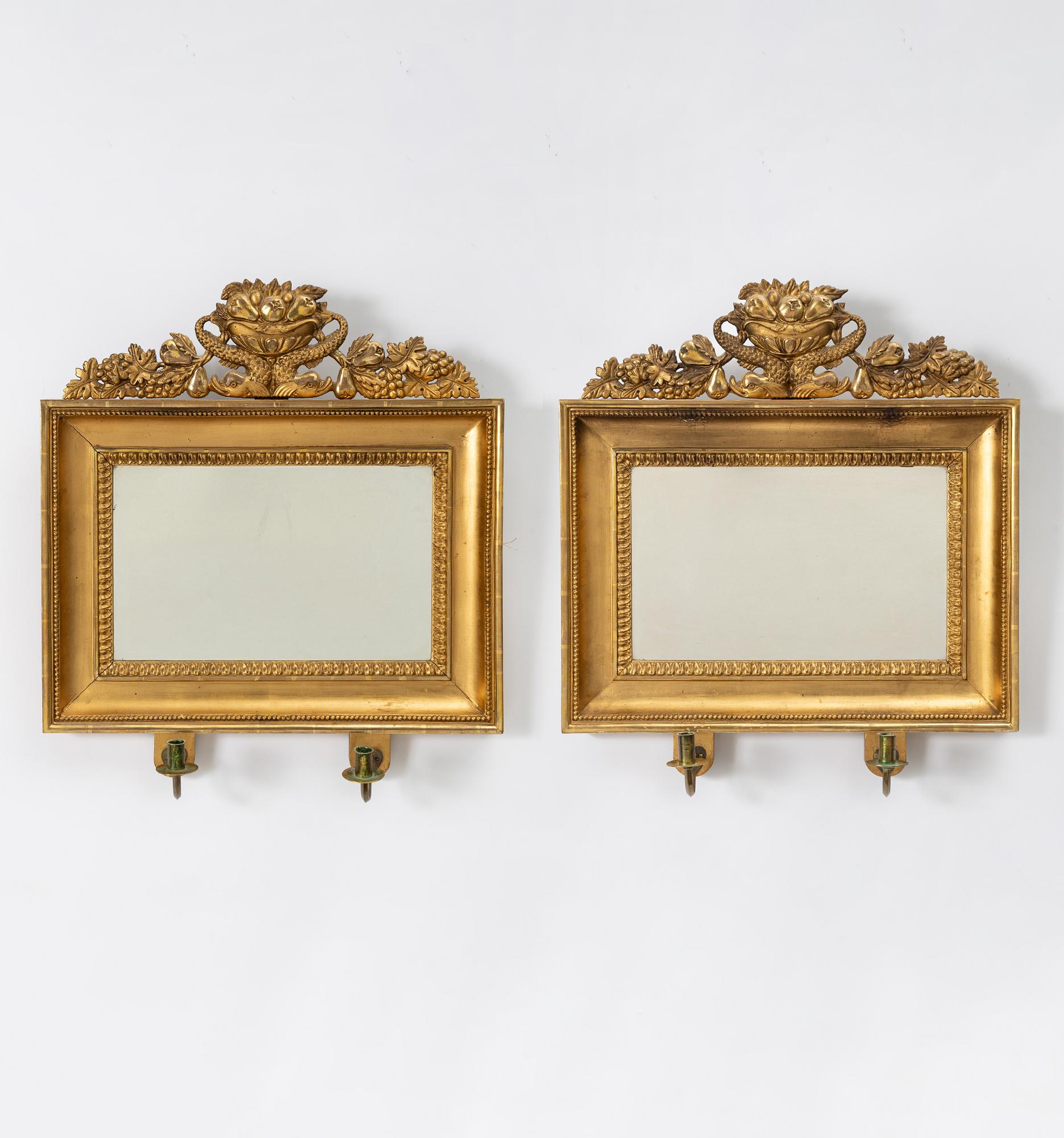 A pair of Empire giltwood two-branch girandole mirrors, Sweden, first part 19th century.