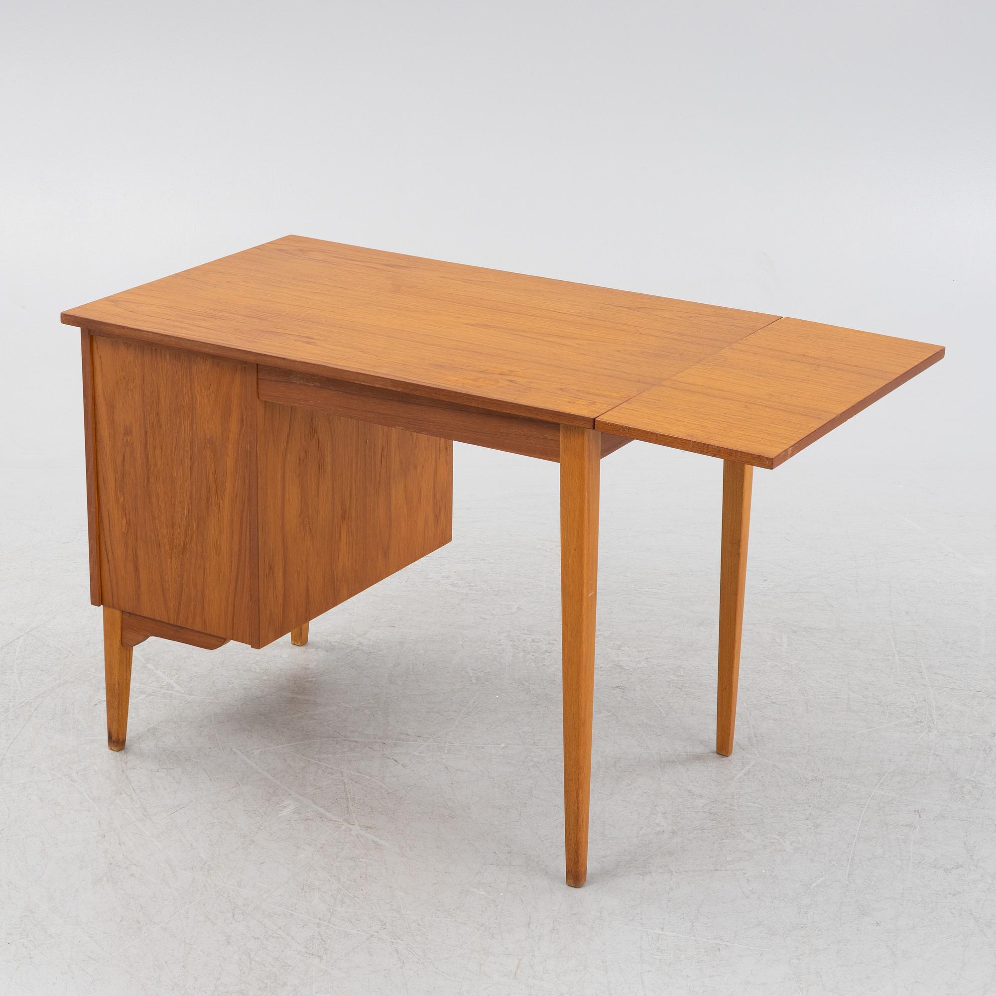 A teak veneered desk, mid 20th Century.
