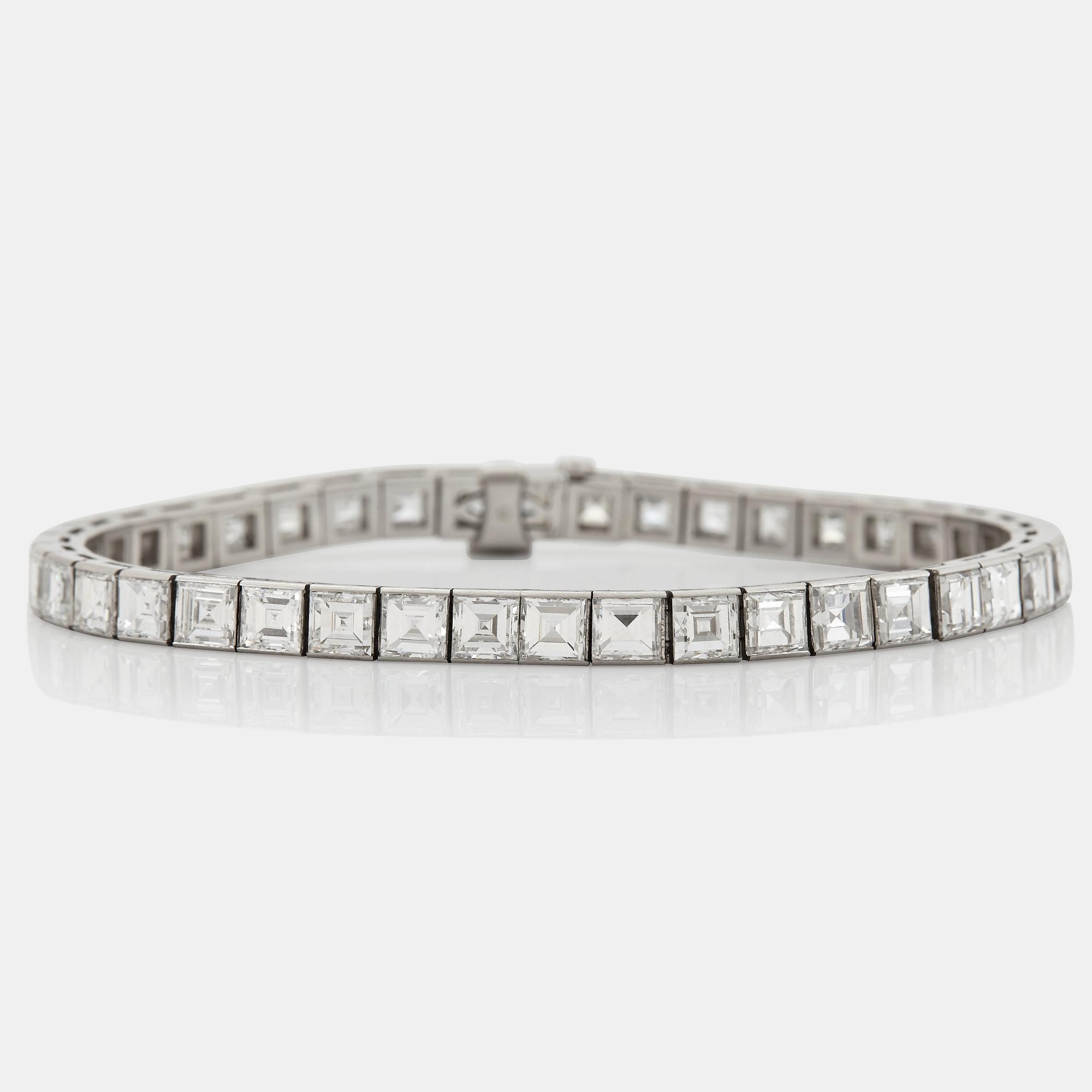 A platinum bracelet set with carré cut diamonds.