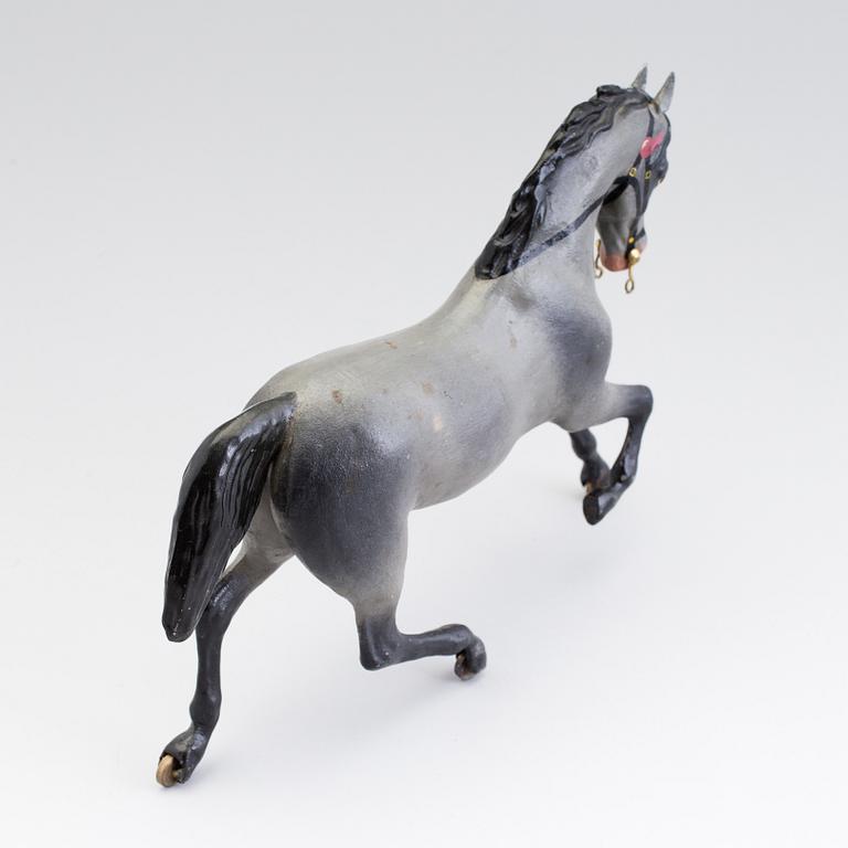 A painted tinplate toy horse ca year 1900.