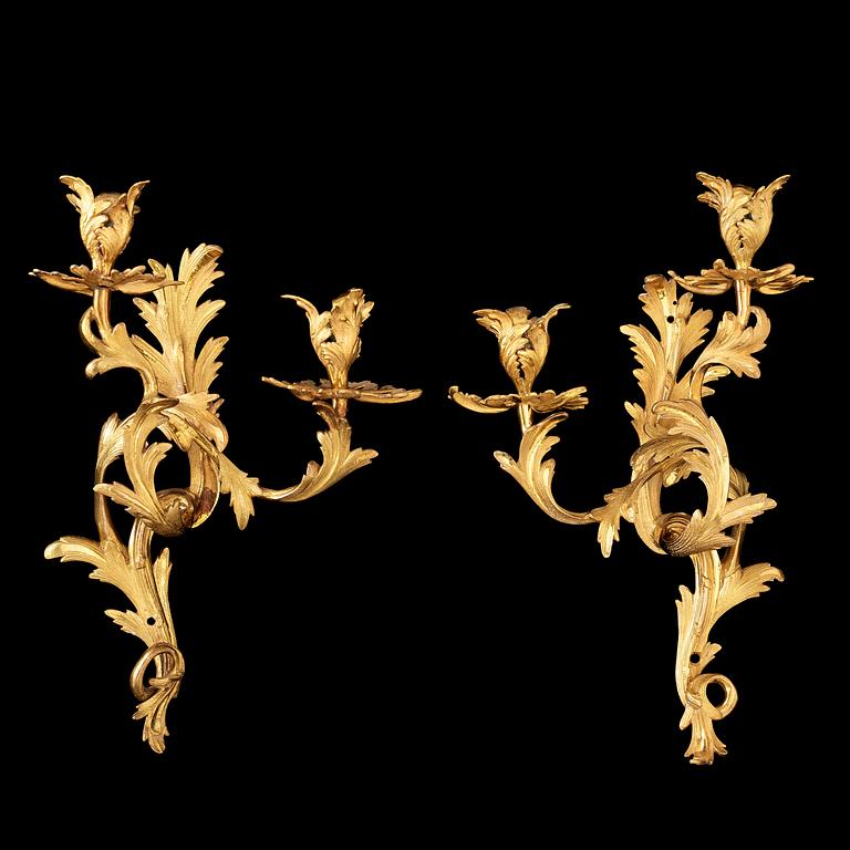 A pair of Rococo 18th century gilt bronze two light wall-lights.