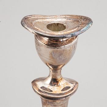 A set of four English 19th century silver-plated candlesticks.