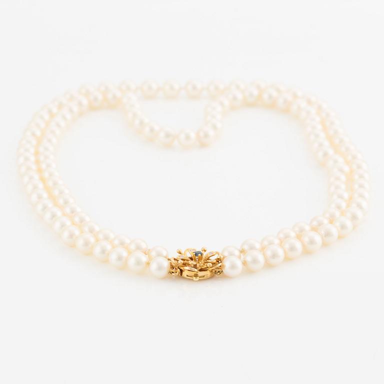 Necklace, double strand of cultured pearls, clasp in 18K gold set with eight-cut diamonds and a sapphire.