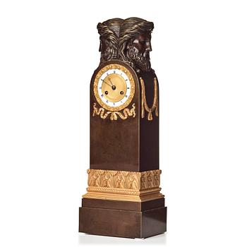 87. An Empire early 19th century gilt and patinated bronze mantel clock.