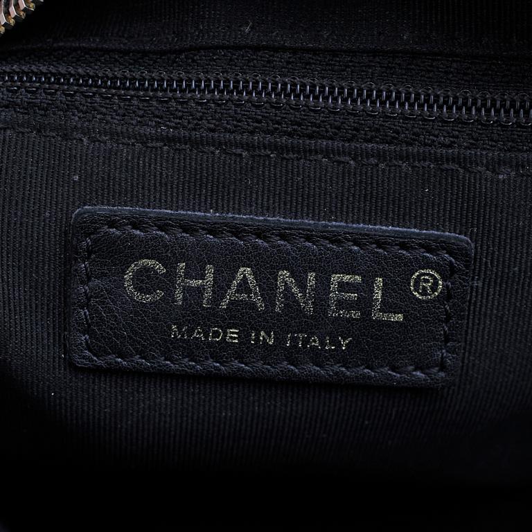 CHANEL, a black leather "Medium Shopping" handbag.