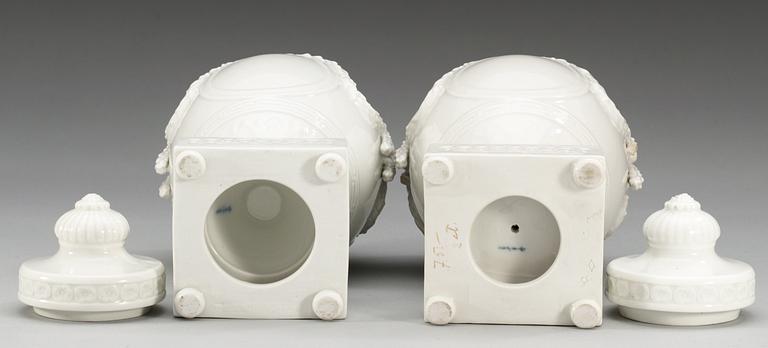 A pair of white glazed Berlin jars and covers, circa 1900.