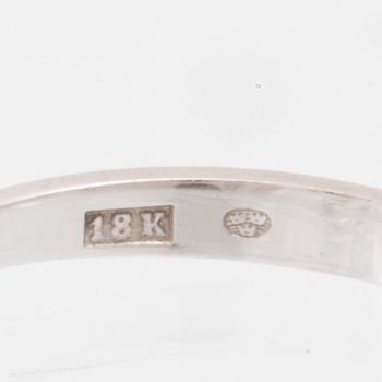 An 18K white gold solitaire ring set with a round brilliant-cut diamond.
