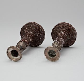 A pair of late Gustavian early 19th Century porphyry and silver candlesticks.