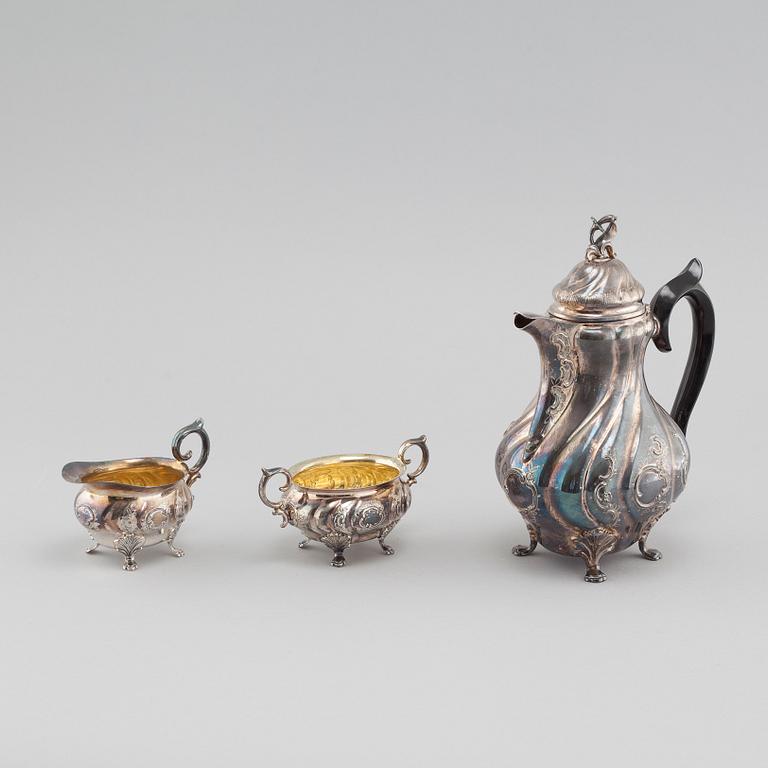 A silver rococo style coffee pot, sugar bowl and creamer from GAB and C G Hallberg in Stockholm, 1950s/60s.