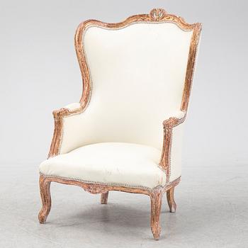 A gilt Louis XV style bergère, first half of the 20th Century.