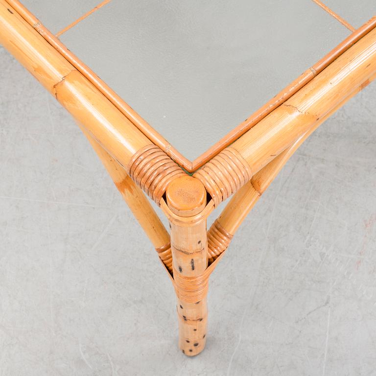 A set of two garden sofas, an armchair and a glass table, later part of the 20th Century.