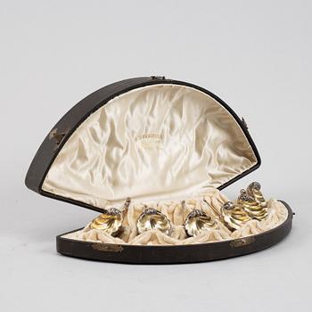 A set of six German parcel-gilt silver 800 salt cellars in fitted case.