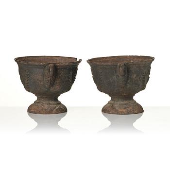 A pair of cast-iron garden urns, presumably from Näfveqvarns styckebruk, dated 1789.