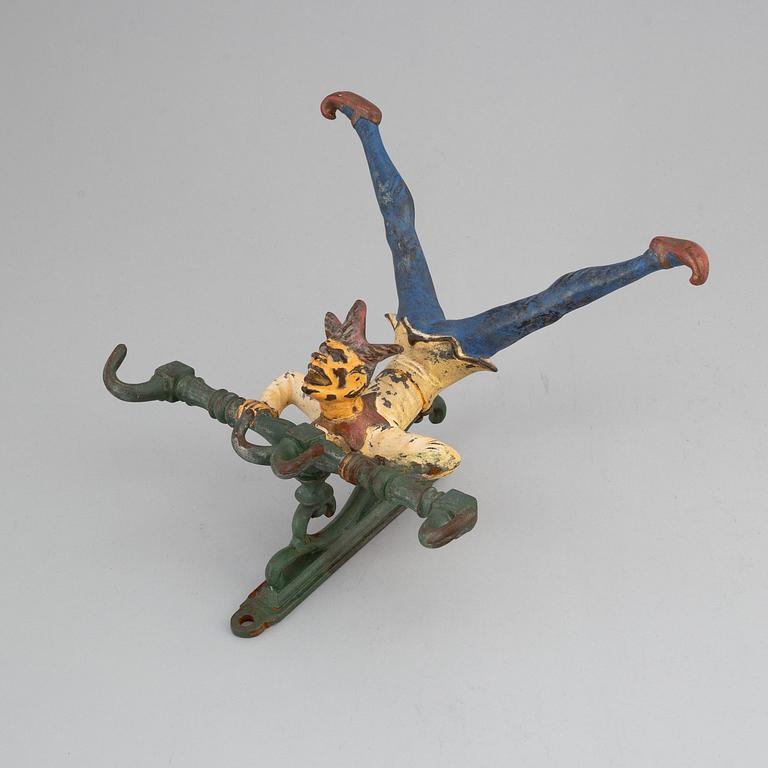A cast iron clothes-hanger from the 20th century.