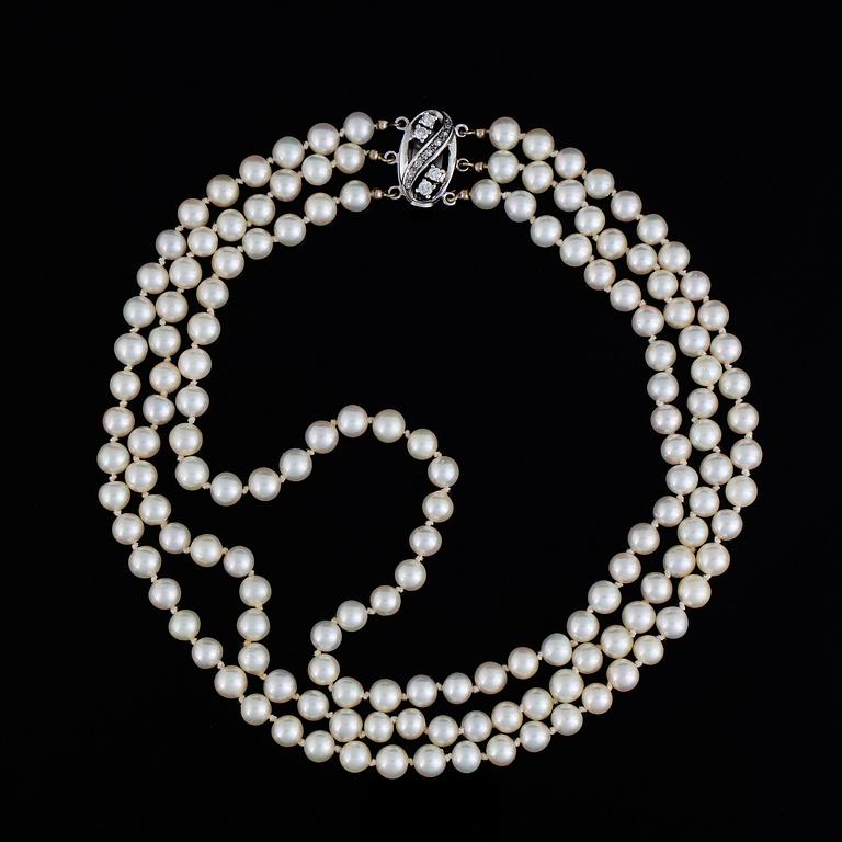 Three strand cultured pearl necklace, clasp with diamonds.