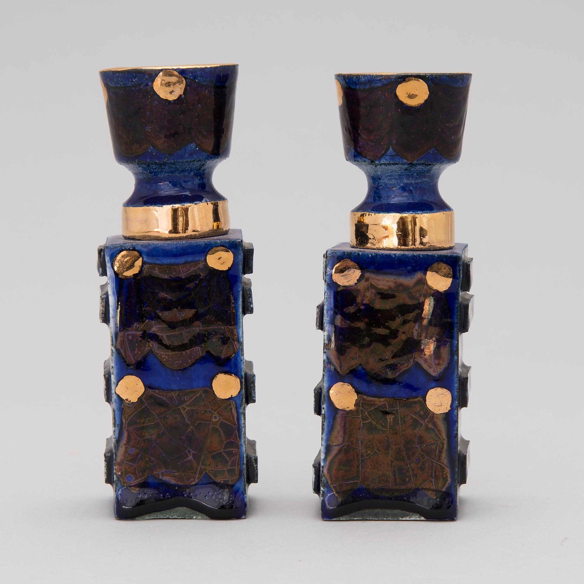 A pair of ceramic candlesticks signed Kaipiainen.