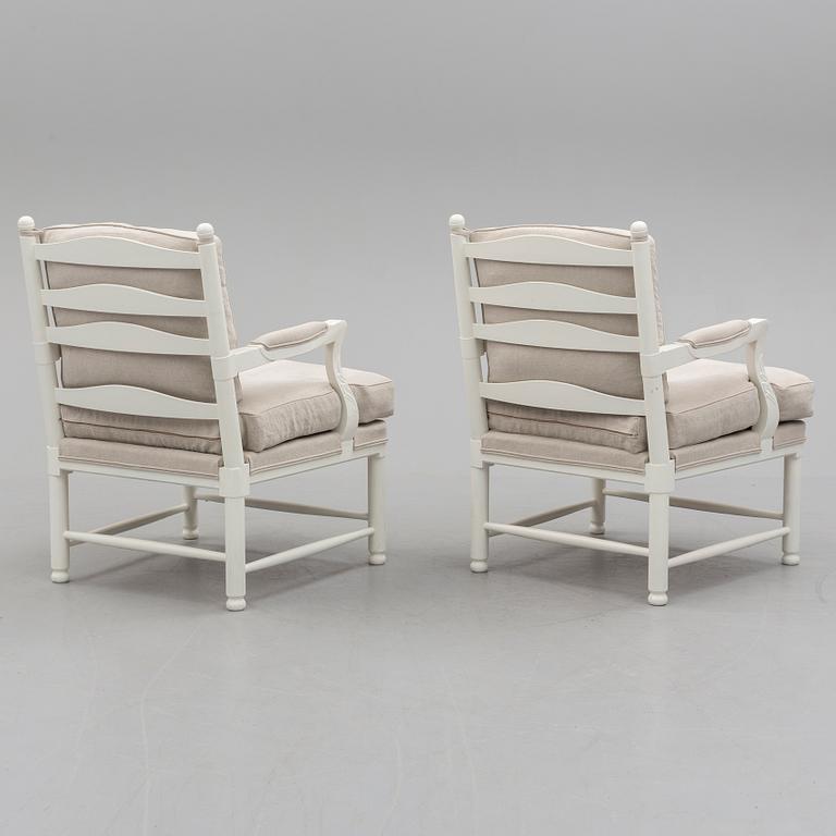 A pair of second half of the 20th century arm chairs.